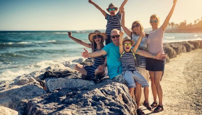 Happy family at the beach enjoying vacation