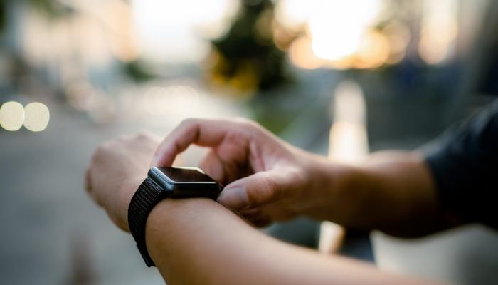 Person checking smart notifications on smartwatch