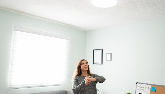 Woman controlling lights with smartwatch
