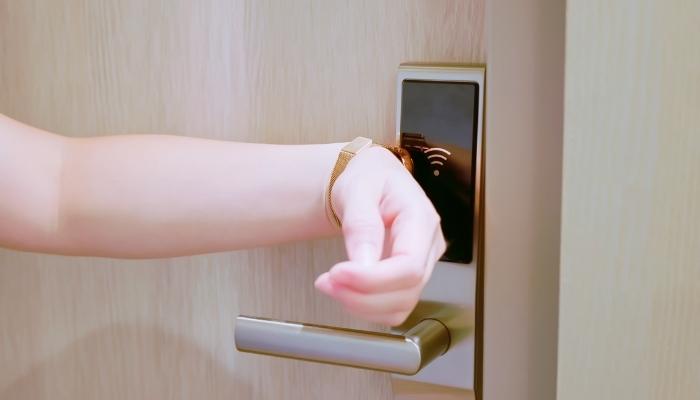Person using smart watch to open smart lock