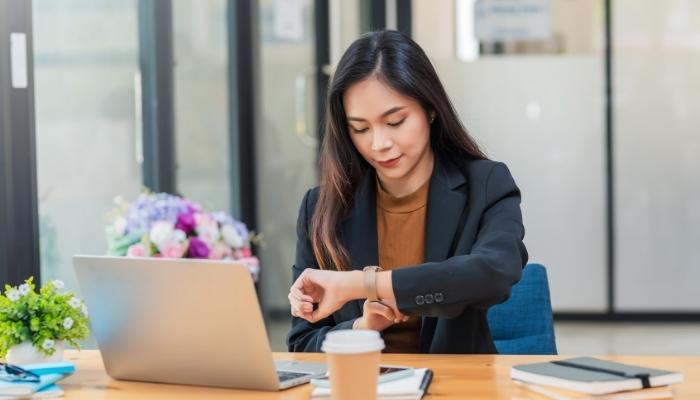 Woman checking smartwatch notifications of smart home
