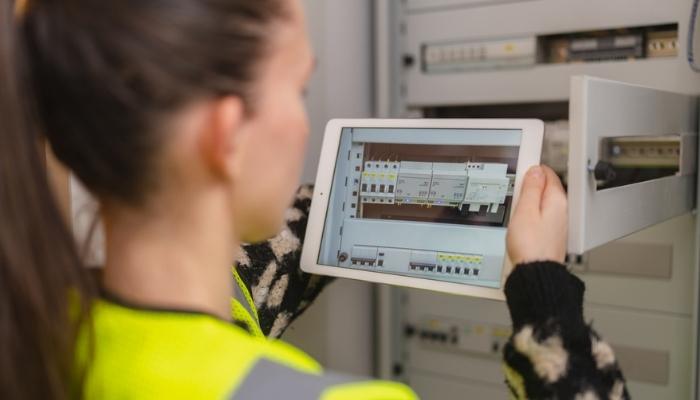 female technician is using a digital tablet and checking wifi