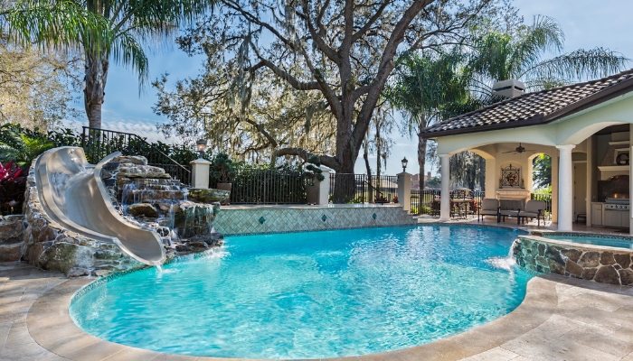 Luxury pool with spa, slide, and waterfall