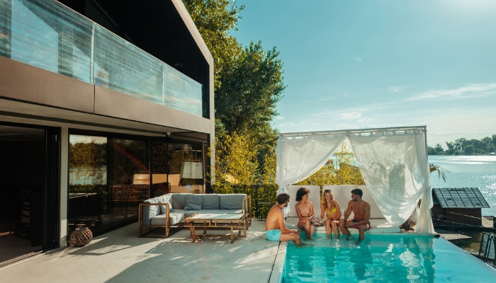 People having a party at the pool with a cabana