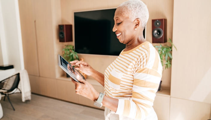 A senior woman enjoying controlling her smart home system
