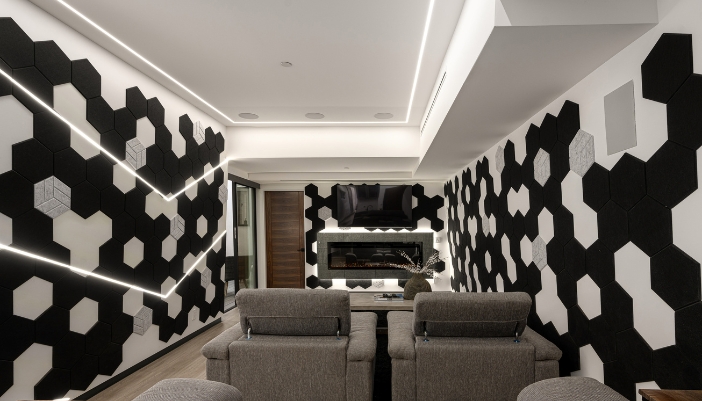 A home theater with extensive acoustic panels on the walls