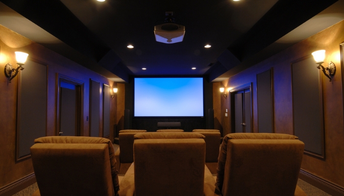 A surface-mounted projector in a dedicated home theater