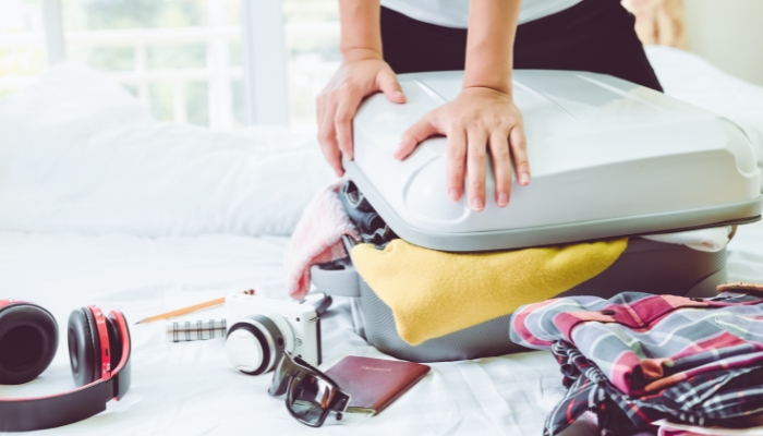 Close up of someone packing to go on vacation
