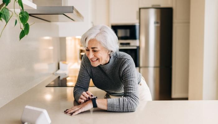 Older woman using voice assistant to control smart home