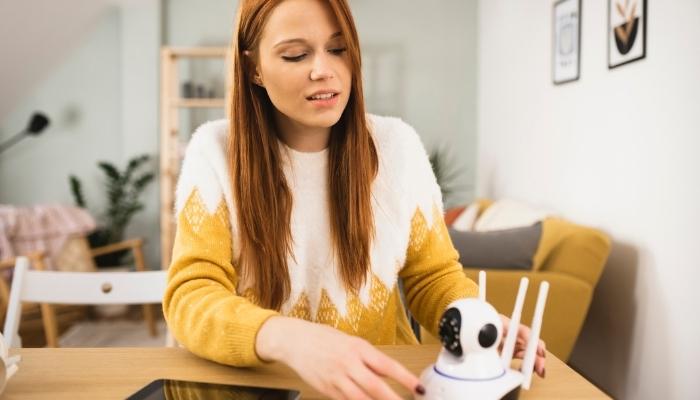 Woman trying to connect wireless security camera