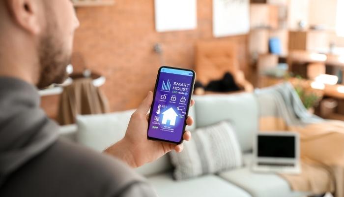 Man using smart home system with phone