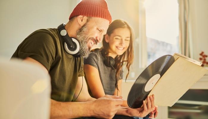 dad and daughter listening to records