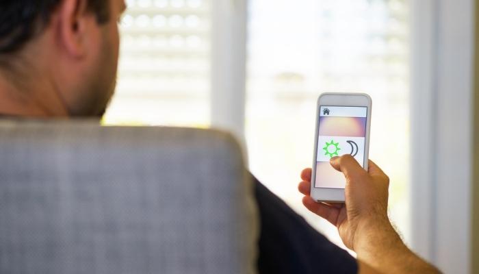 man using smart shade automation 
