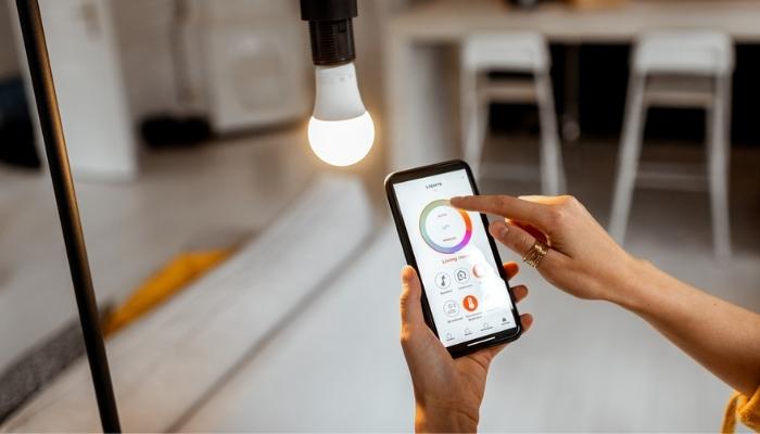 person adjusting light temp