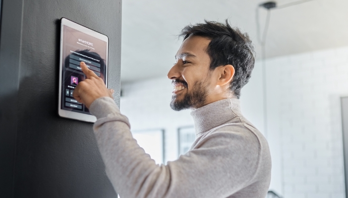 Man using discreet control panel to direct his smart home