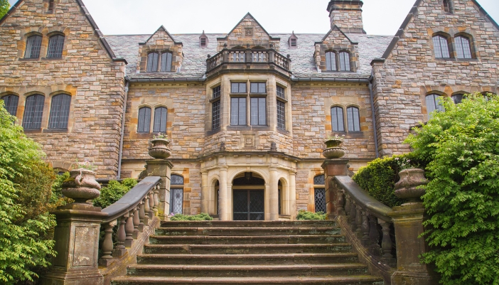 Closeup of a historic mansion with stone steps