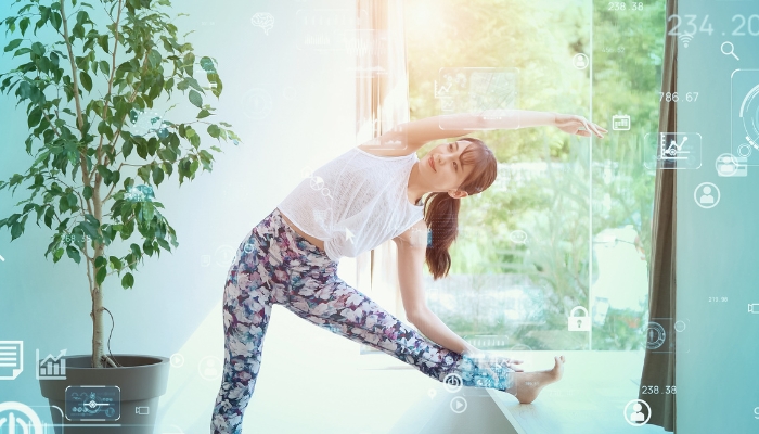Woman working out with tech symbols overlaying the image