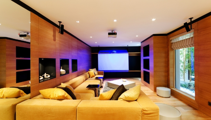 Game room setup with projector and several high-def speakers