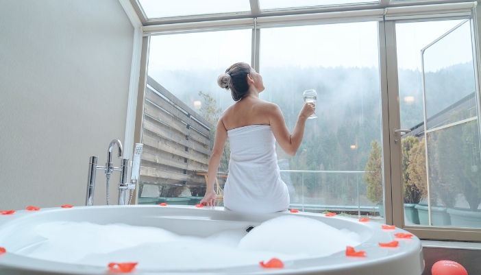 Woman enjoying the sounds and scents in luxury home spa