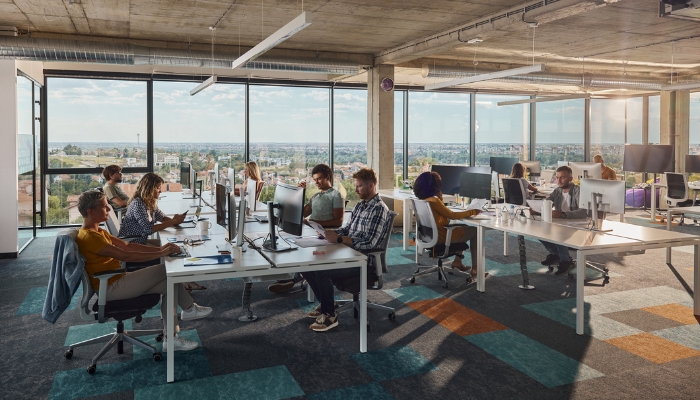 Woman feeling ill at the noise in the office