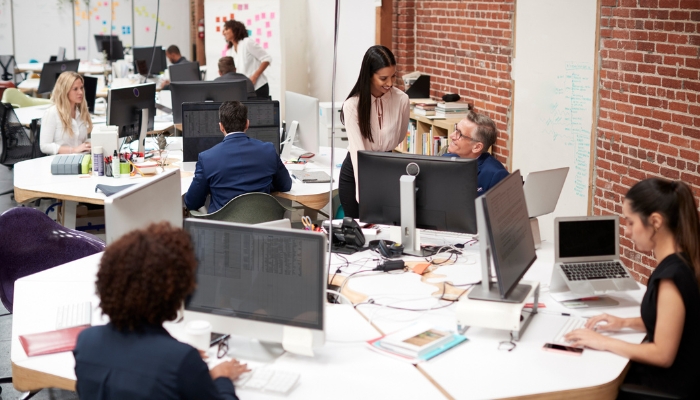 A busy work office with hubs of activity working seamlessly