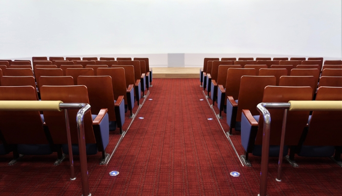 An auditorium with pathway lights
