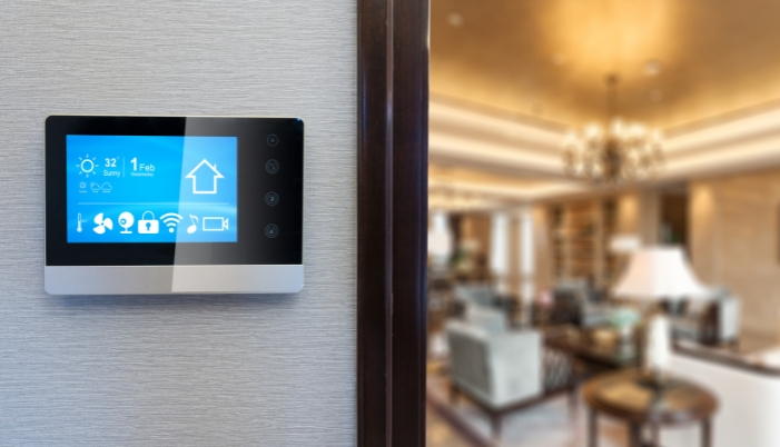 A luxury home with a smart control panel outside of a room
