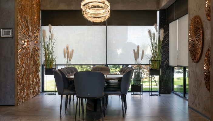 Smart shades in a dining room with an automated filtering screen to block out harsh light