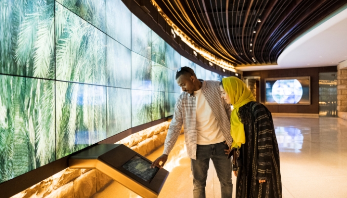 couple looking at interactive video wall display