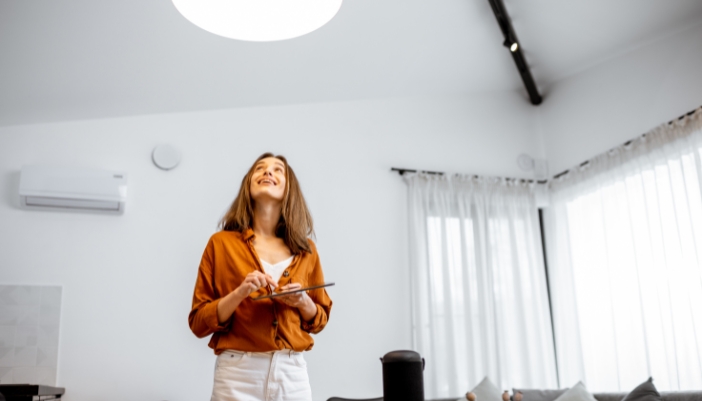 woman using smart lighting on tablet