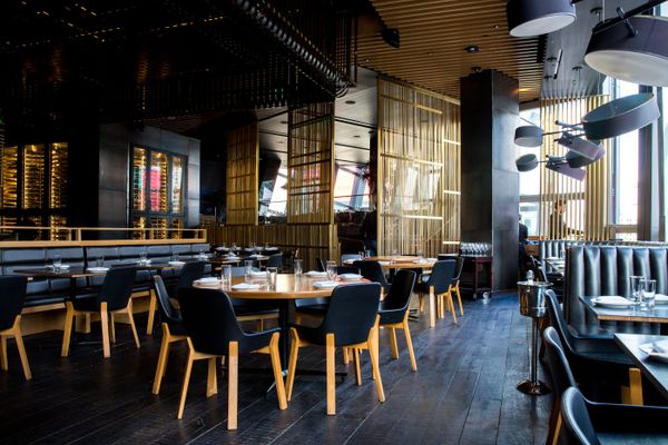 An elegant restaurant with a gold and black color scheme