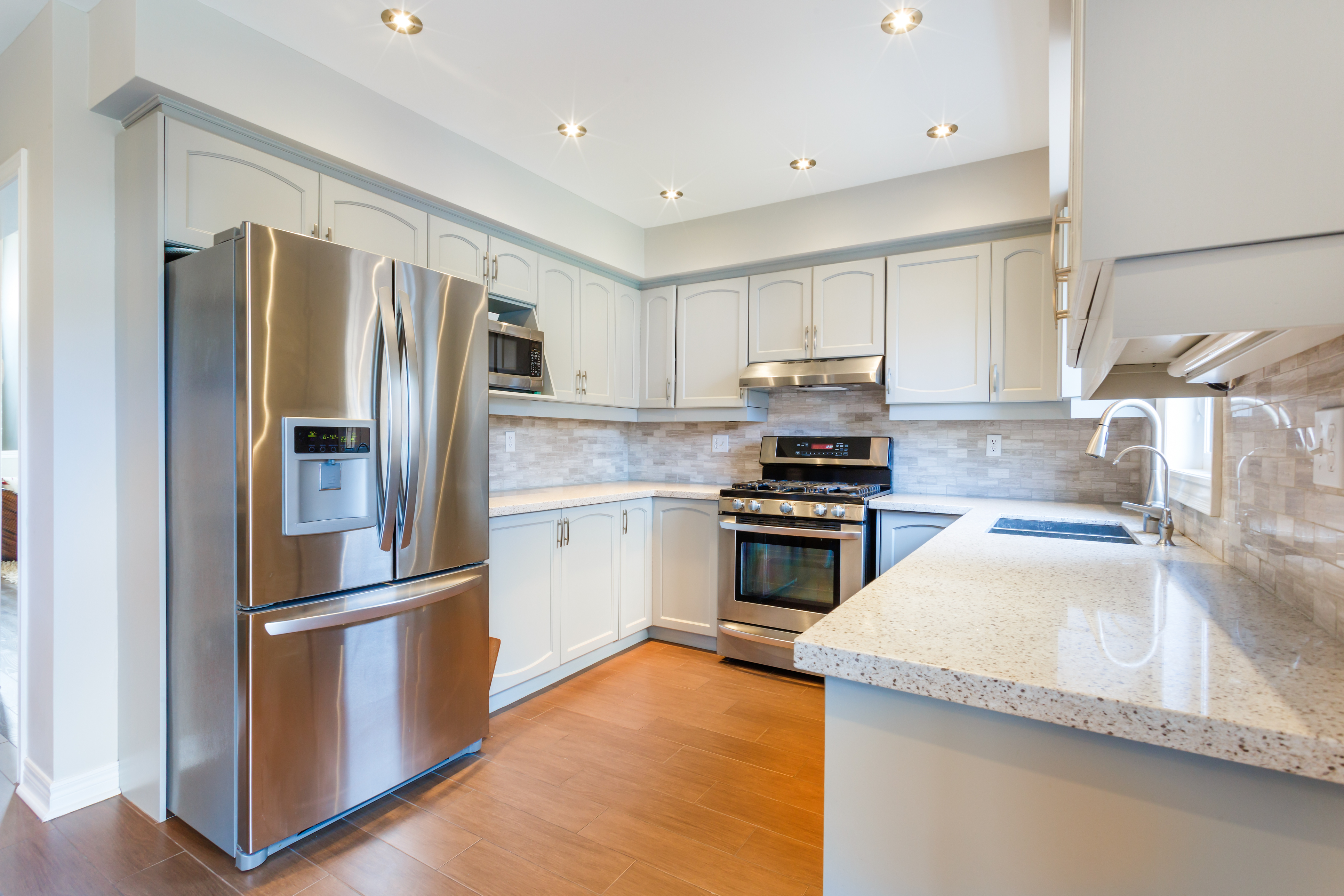 Full view of kitchen with stainless steel French door refrigerator