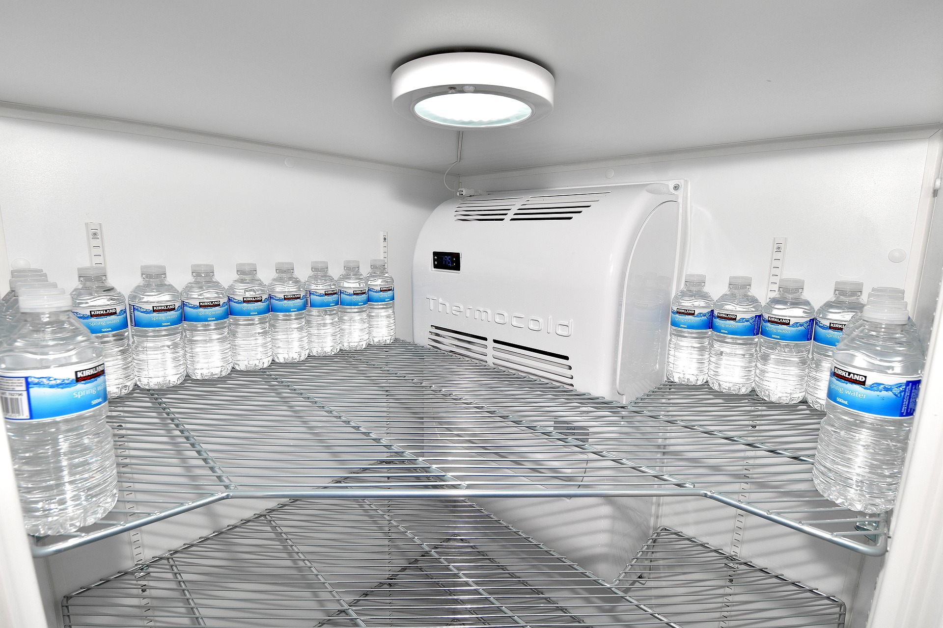 Interior of new refrigerator with water bottles