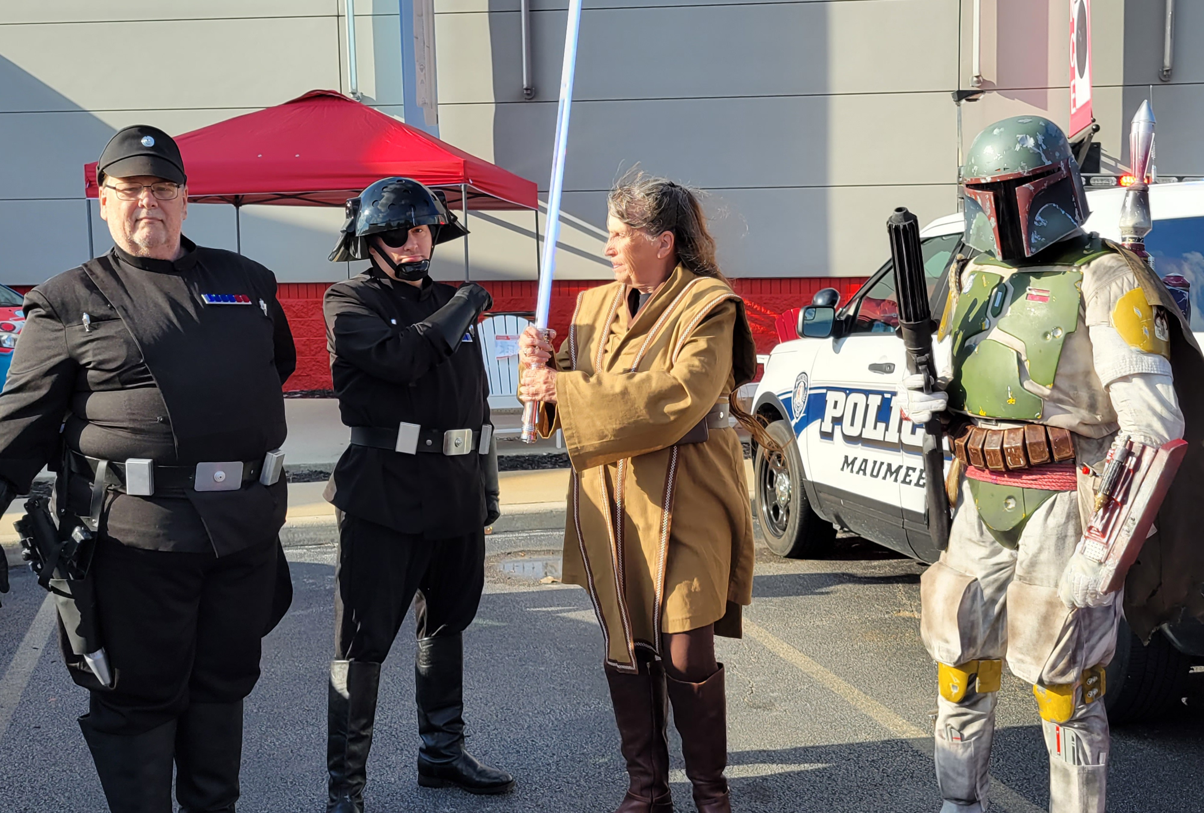 Adults dressed in Star Wars-themed costumes for Trunk or Treat event