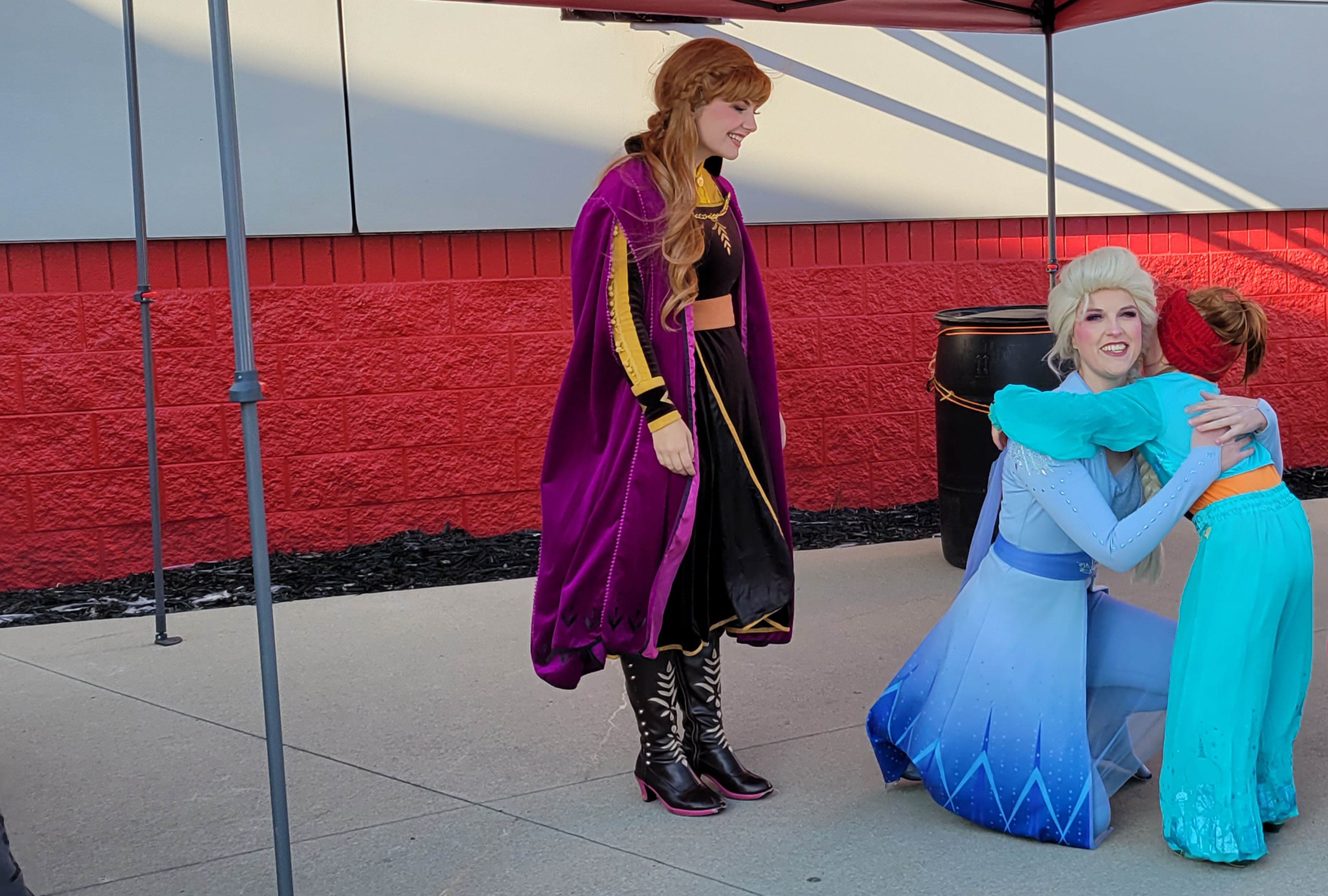 Little girl meeting princesses from Disney's Frozen