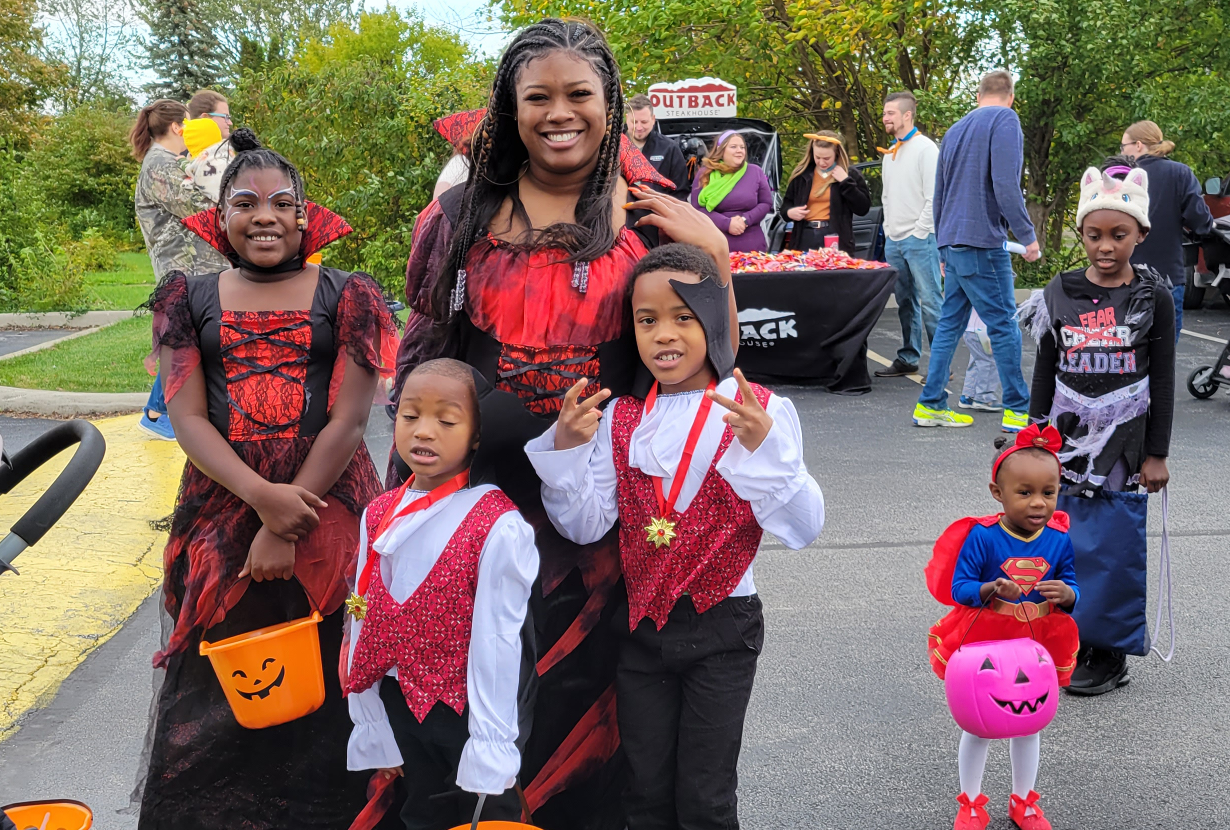 Family dressed in red and black theme poses for the camera