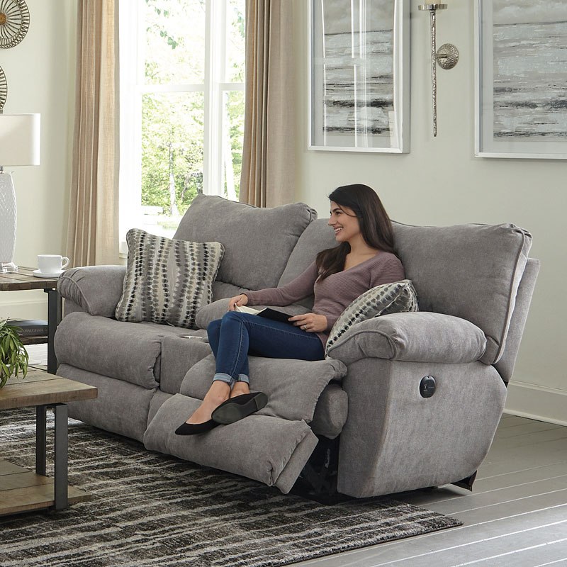 young woman dressed in casual clothes smiles on a contemporary style sofa
