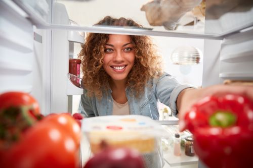 Woman Looking Inside Refrigerator