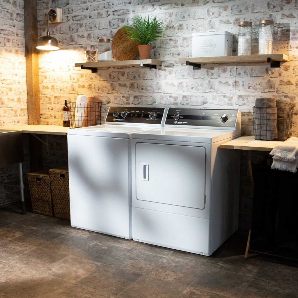 Woman takes laundry out of a Speed Queen dryer