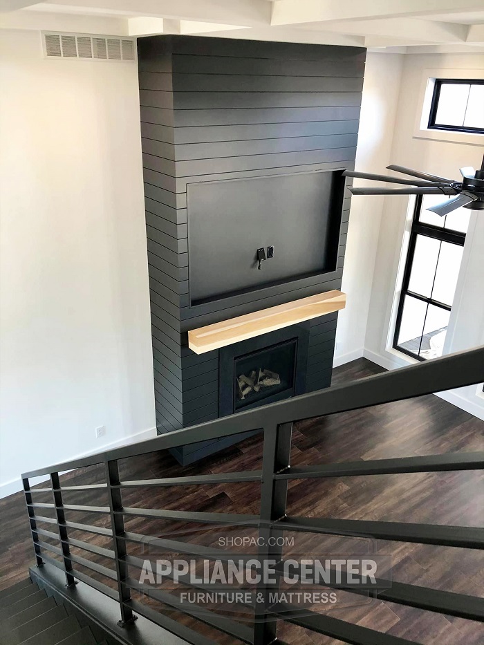 Set of stairs leading down to a fireplace.