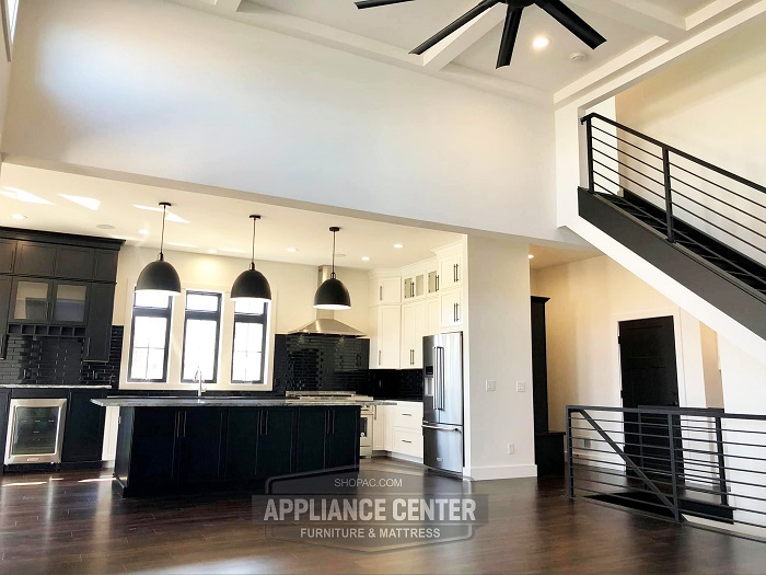 Long view of a very open and wide kitchen.