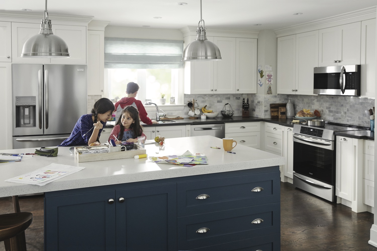 Mother and two children doing chores and homework in a kitchen 