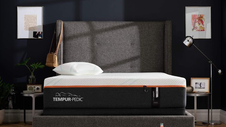 Wide shot of Tempur-Pedic memory foam mattress on a wingback bed frame