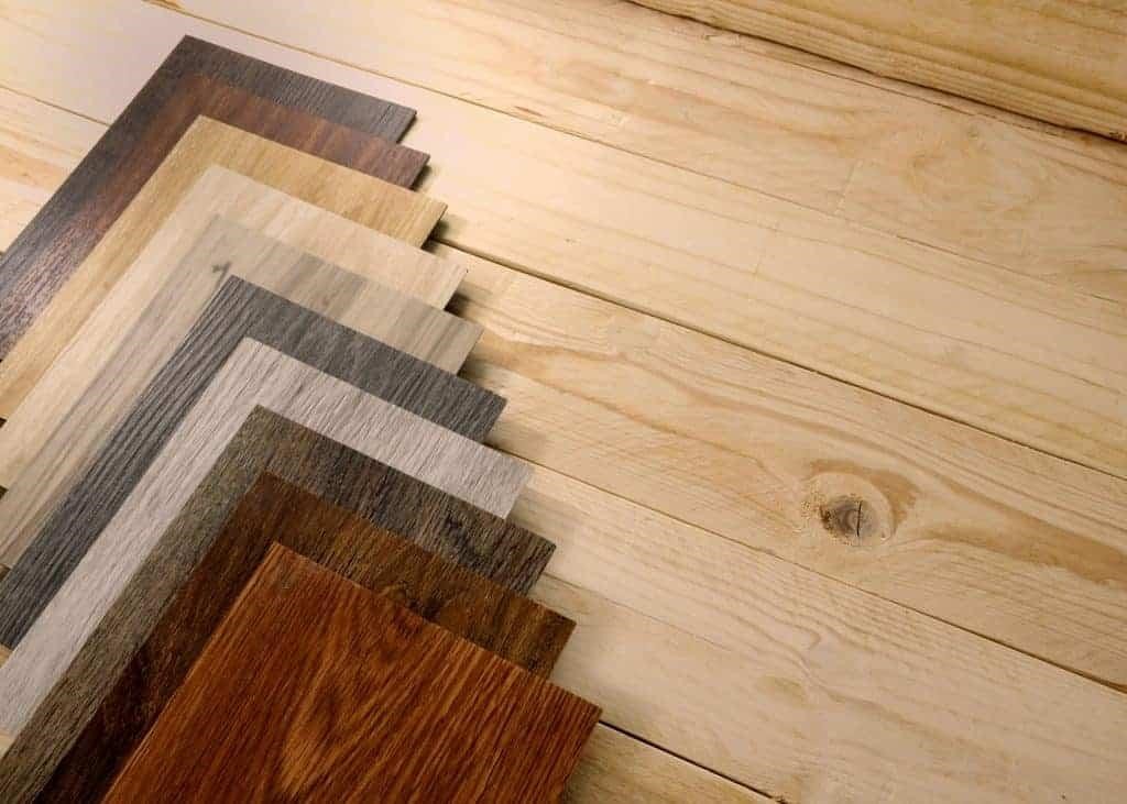 Multiple flooring samples on a wood laminate floor