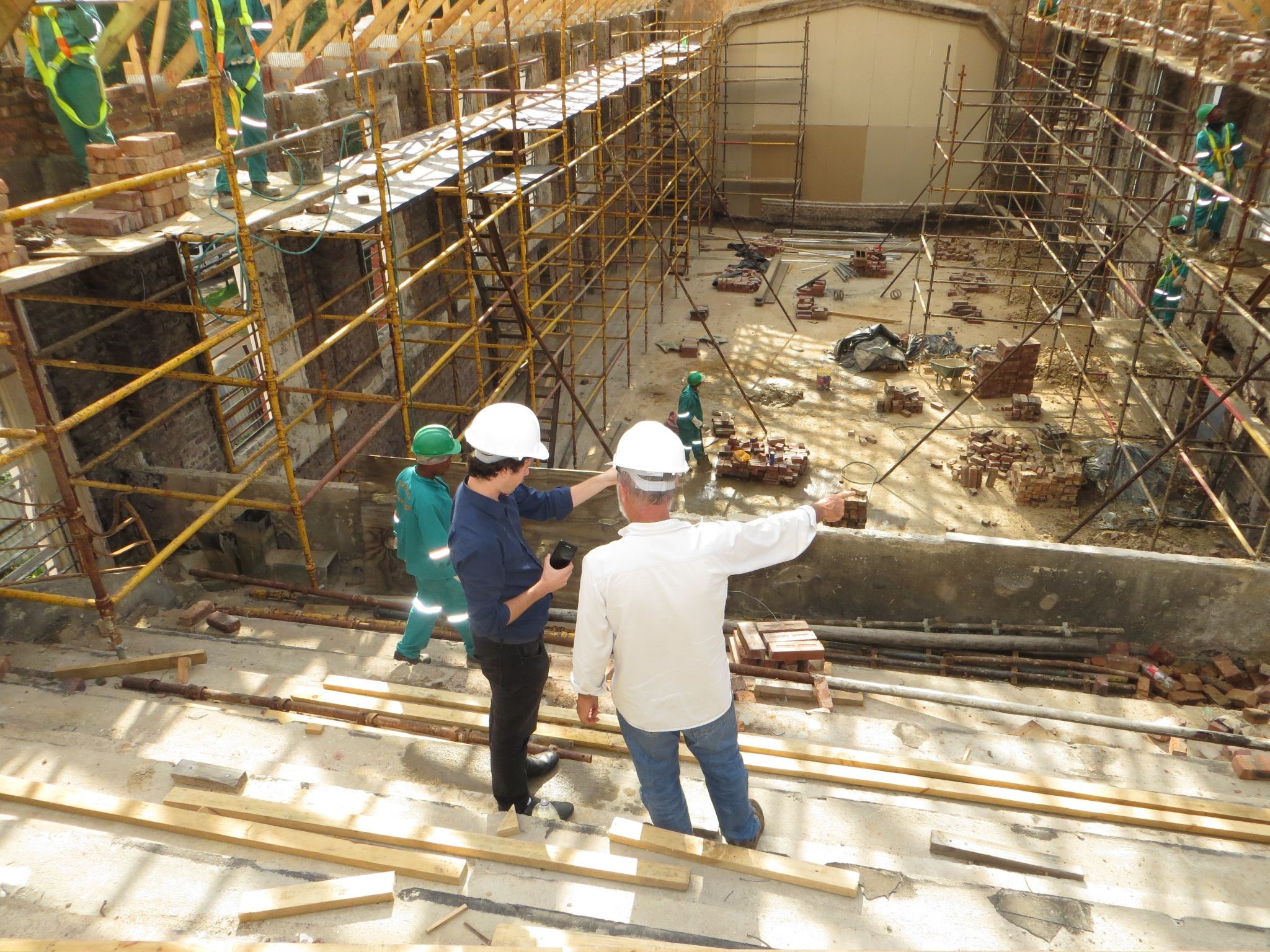 Builders have a conversation while overlooking job site
