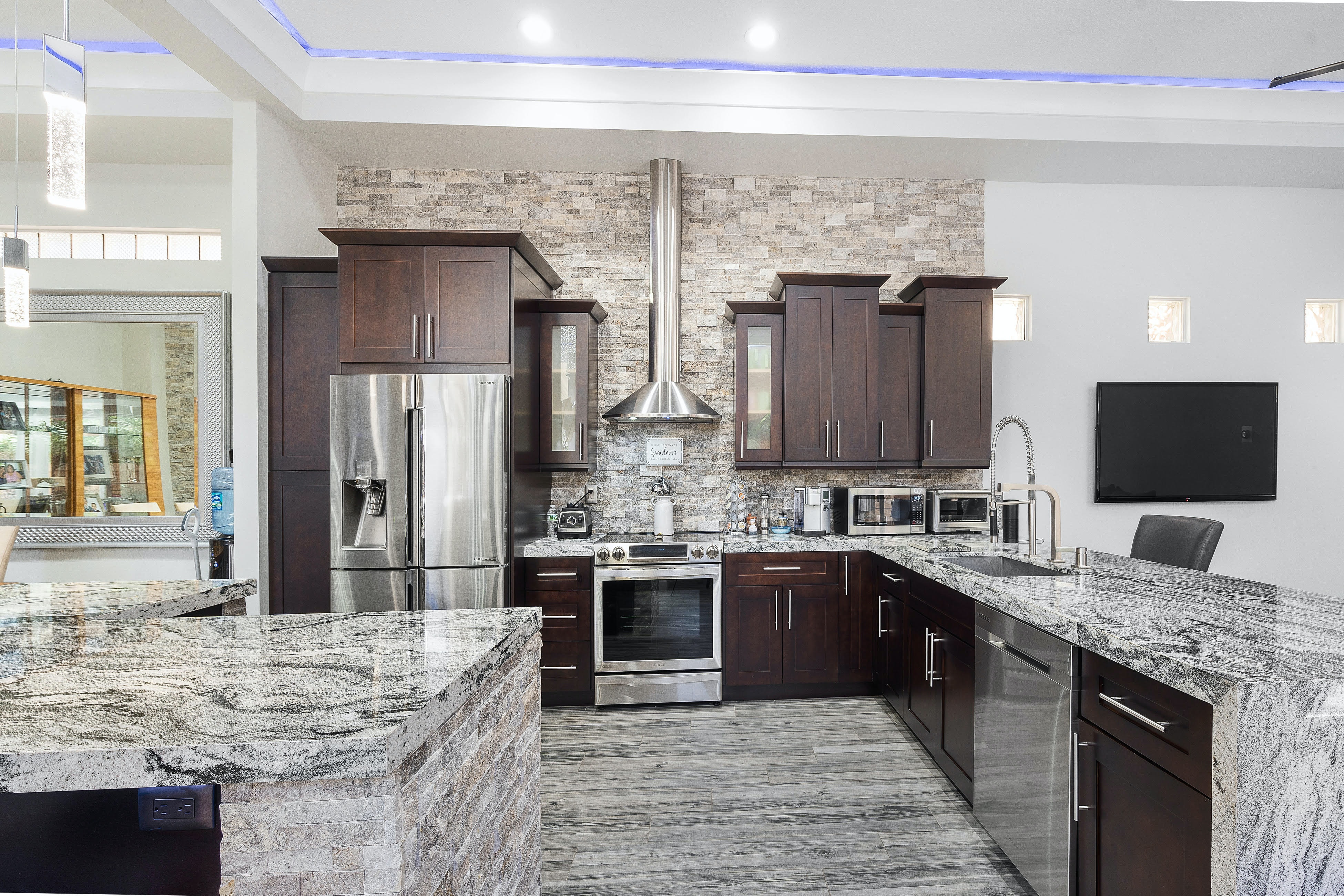 High end kitchen with stainless steel appliances and marble counters