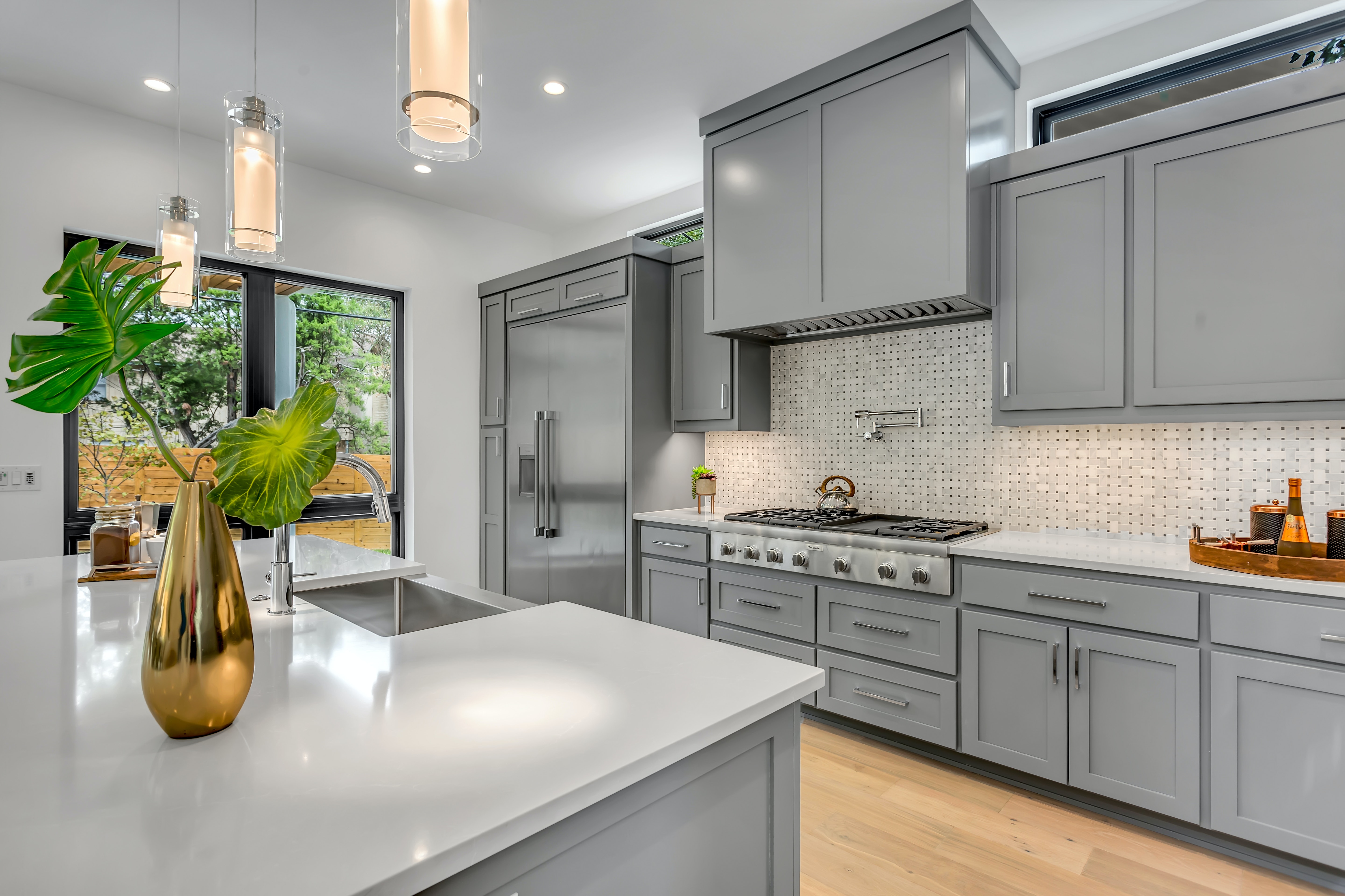 Modern kitchen with gray cabinets and high end appliances