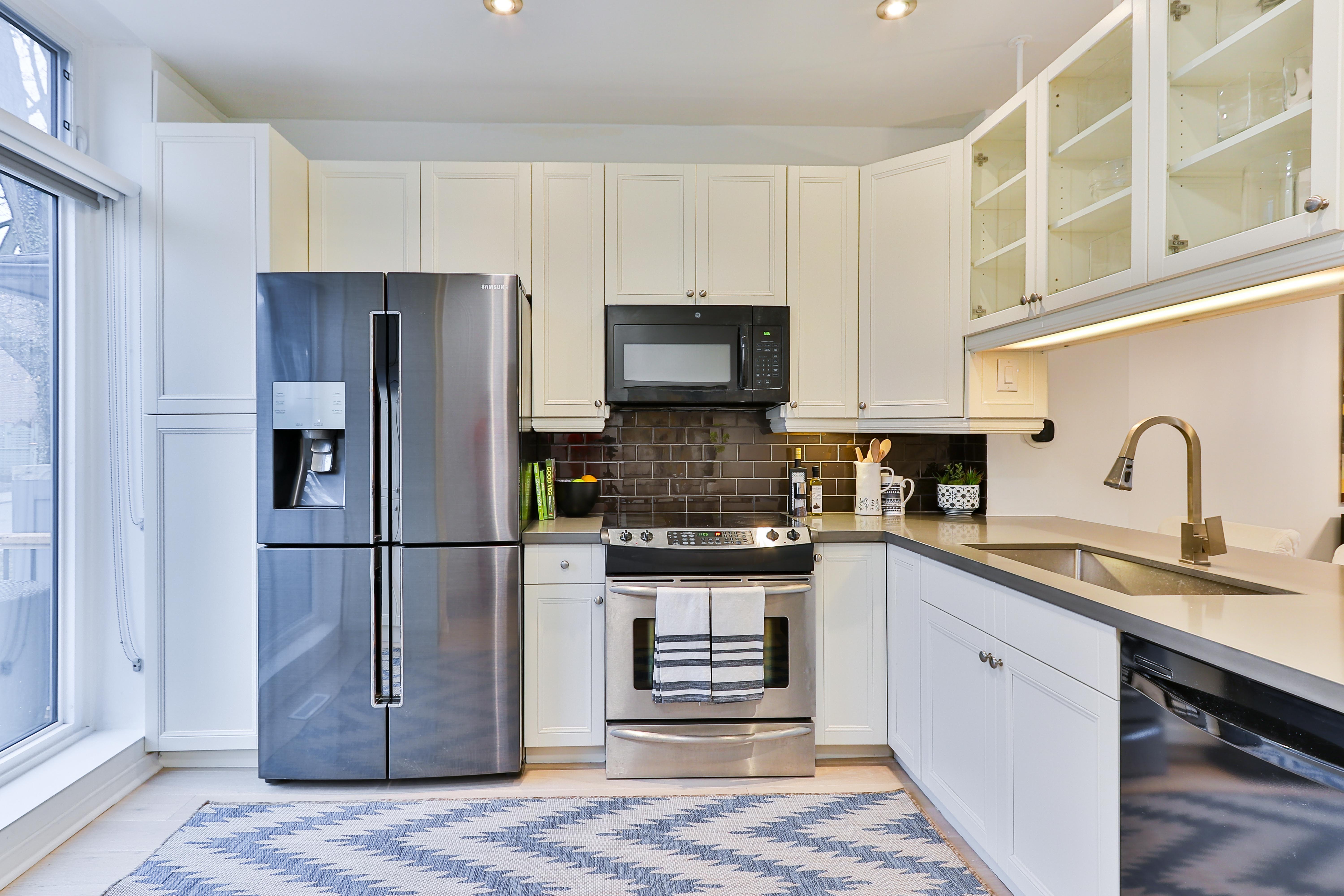 Contemporary L style kitchen with aluminum appliances 
