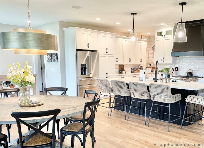 Open concept kitchen with dining area nearby in new home built in Bettendorf Iowa. Kitchen design and lighting by Village Home Stores for Aspen Homes of the Quad Cities.
