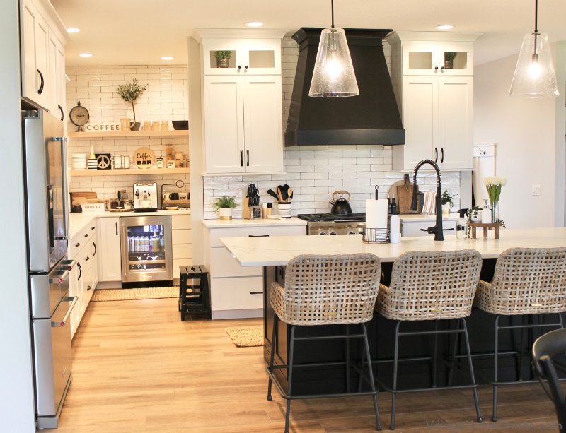 Image of kitchen design with white and black cabinetry and walk in coffee bar pantry with white oak floating shelves